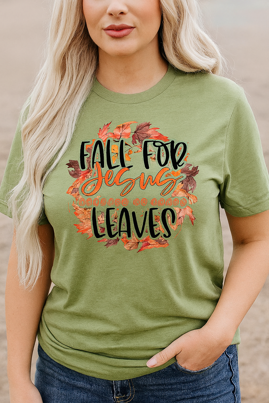 Green short sleeve graphic tee with "Fall For Jesus Because He Never Leaves" text and fall leaves design