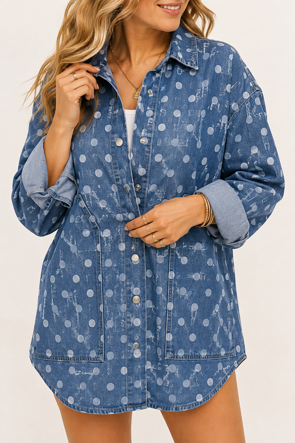 Close view of the Bluebell denim shacket showing ivory polka dots, silver snaps, oversized patch pockets and rolled cuffs.