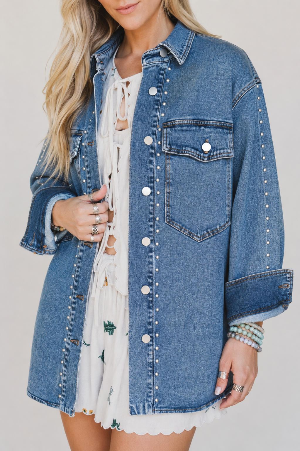 Close view of the Silver Spur denim jacket showing silver rivets, metal buttons, chest pockets and rolled cuffs.