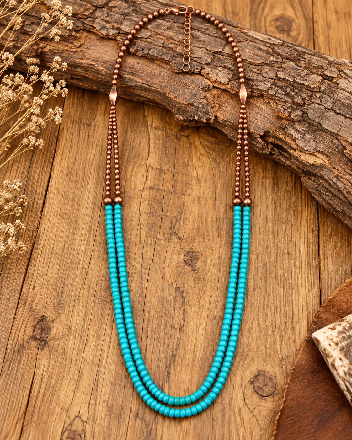 Mesa Trail necklace styled on rustic wood with turquoise-colored beads and warm copper-tone details