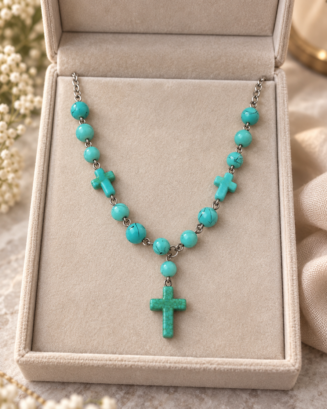 Desert Faith turquoise-tone necklace displayed in a neutral jewelry box with three cross details