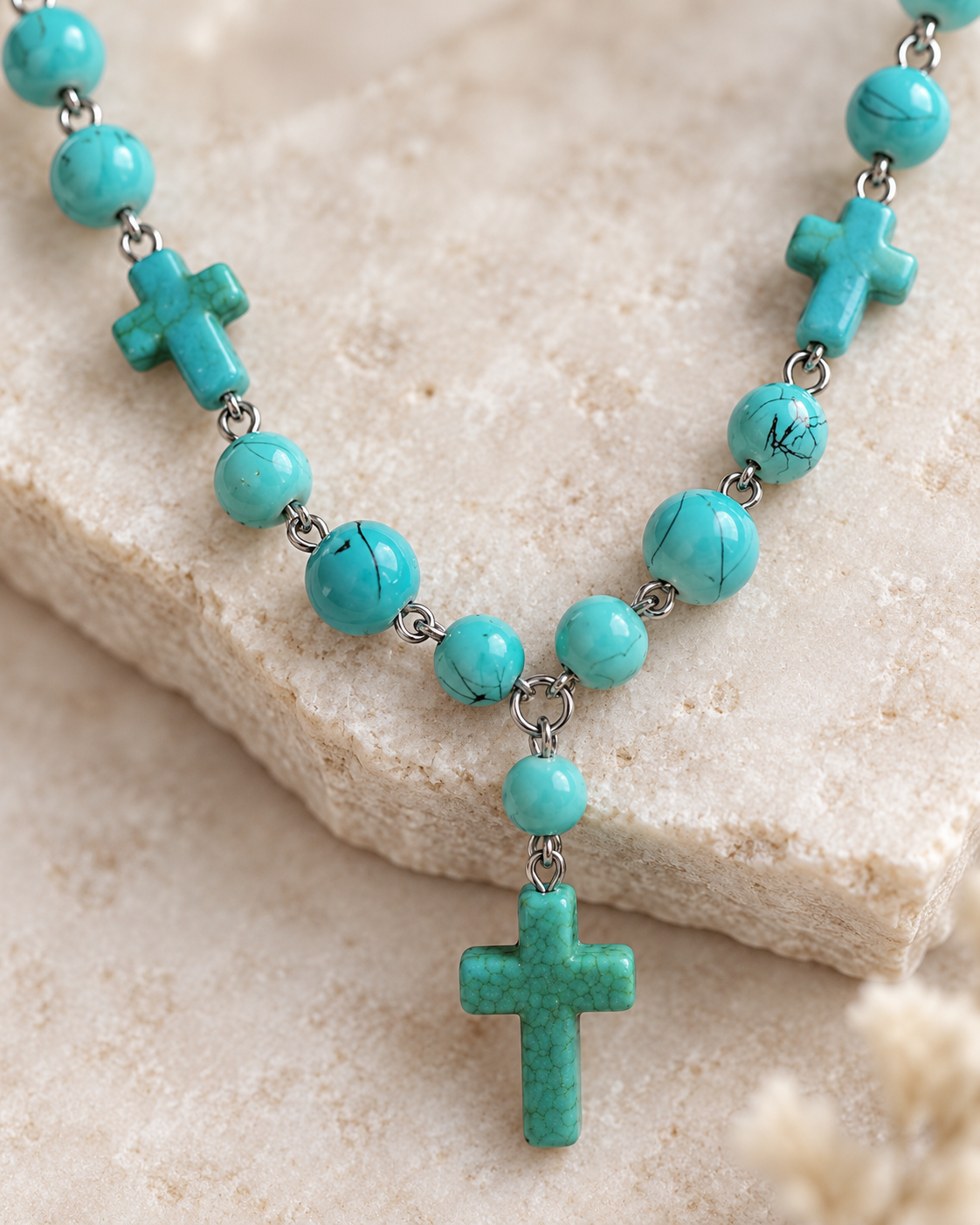 Close-up of turquoise-tone beads and cross accents on the Desert Faith western-inspired necklace