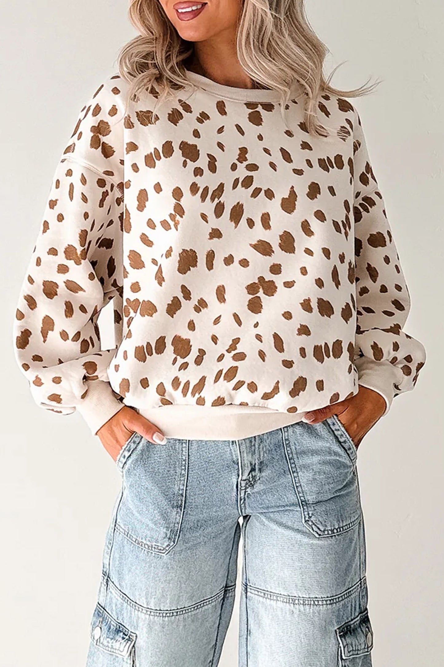 Close-up of the ivory Prairie Fawn sweatshirt showing its brown deer-inspired spotted print