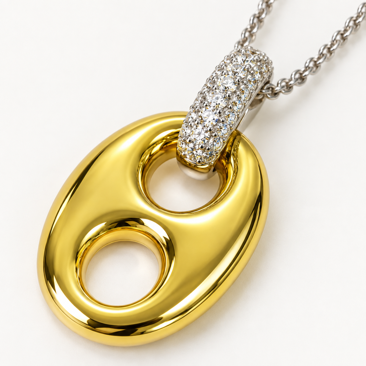 Close-up of gold horse bit pendant with silver crystal connector