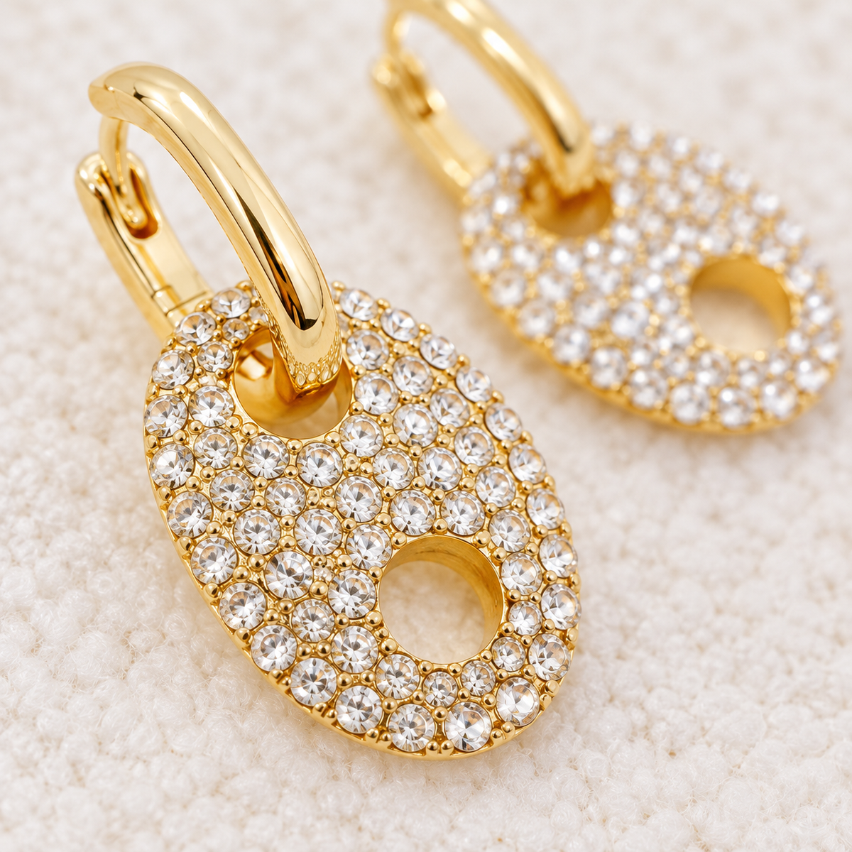 Close-up of clear rhinestones on gold horse bit drop earrings