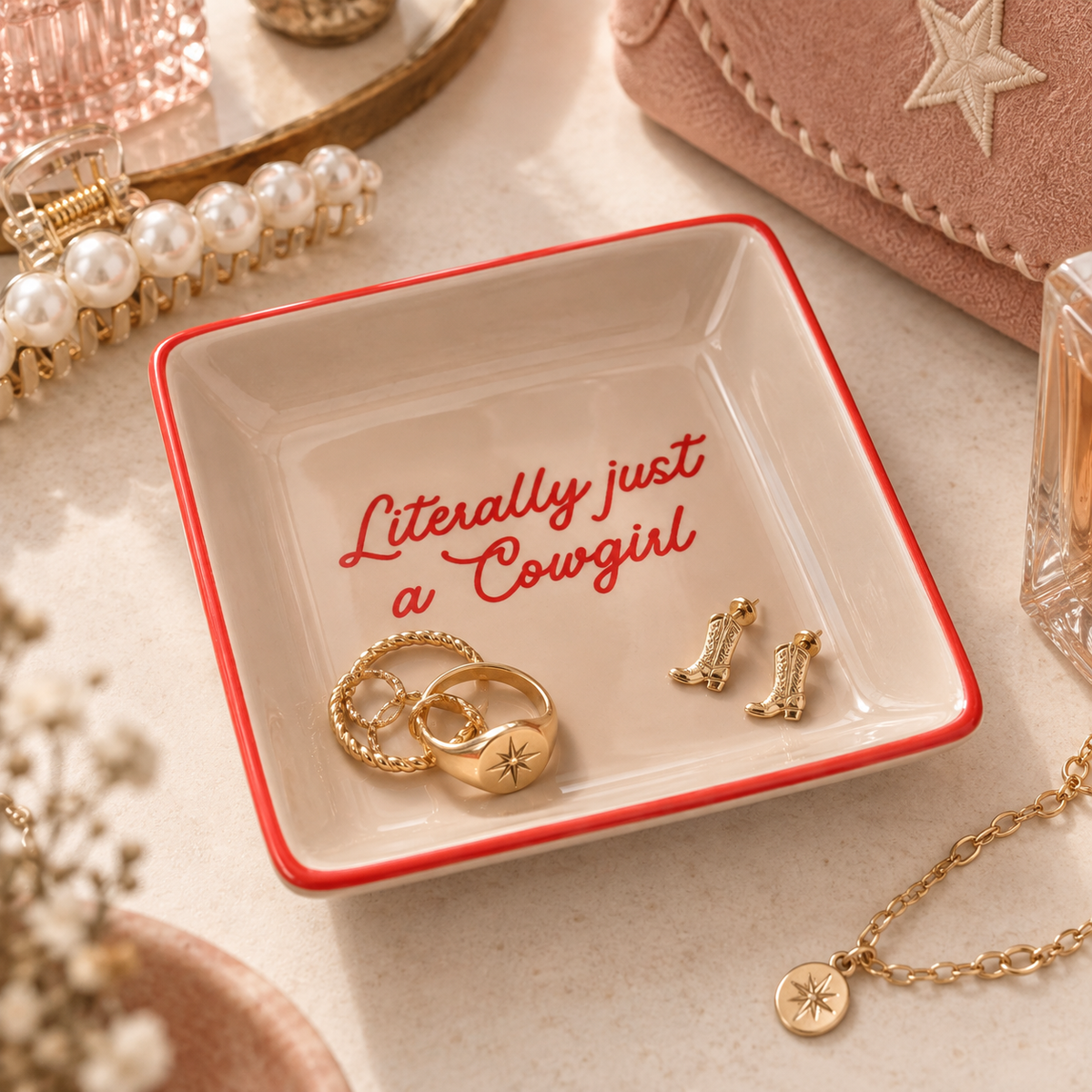 Literally Just A Cowgirl trinket tray styled on a feminine western vanity with gold rings and earrings