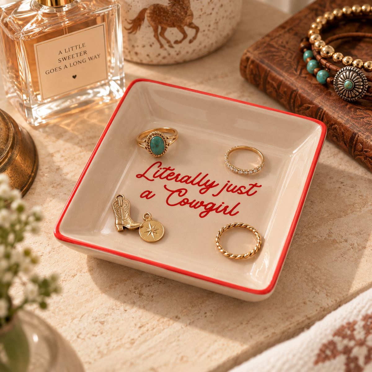 Western cowgirl jewelry tray styled with rings, charms and vanity accessories