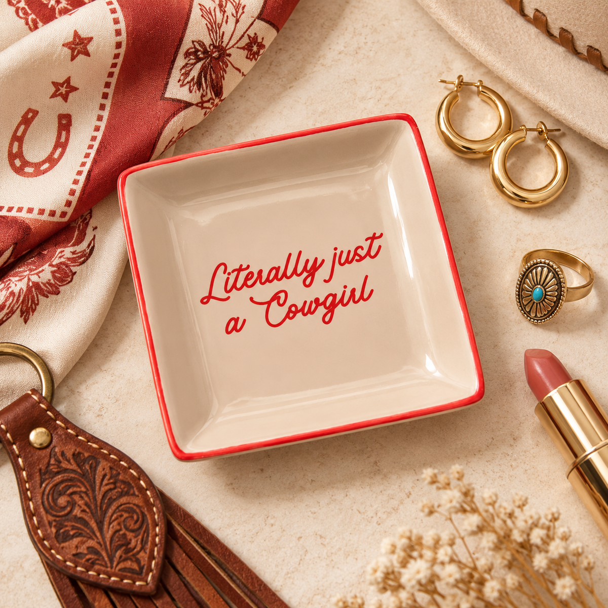 Literally Just A Cowgirl western jewelry dish styled with gold hoops, ring, lipstick and bandana