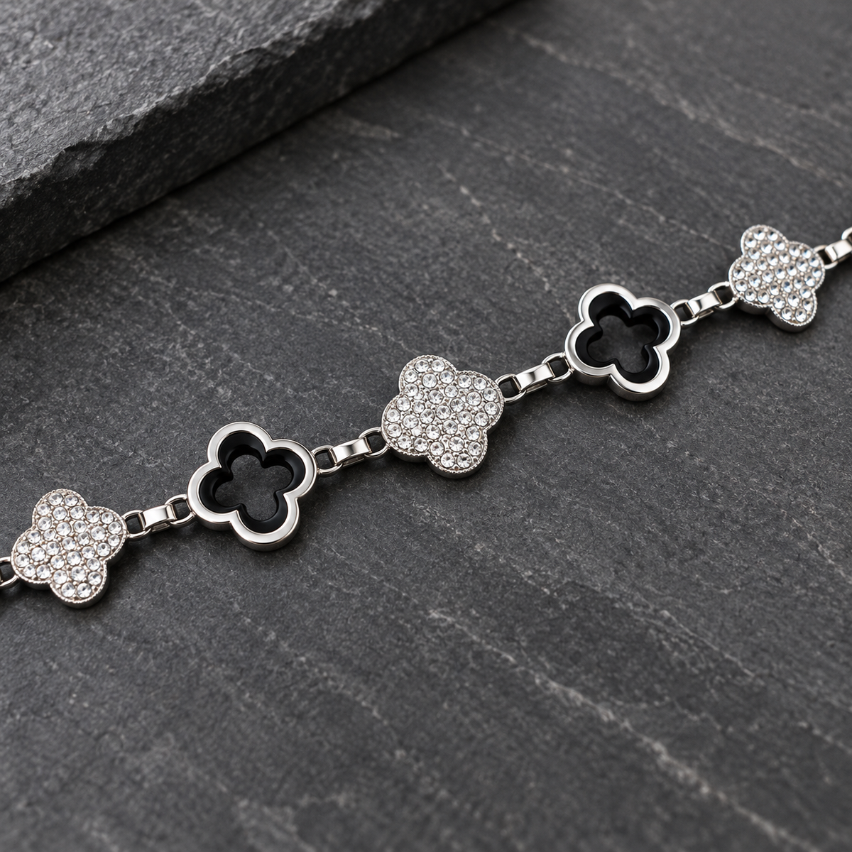 Close-up of silver-tone open quatrefoil and clear rhinestone links on the City Lights chain belt