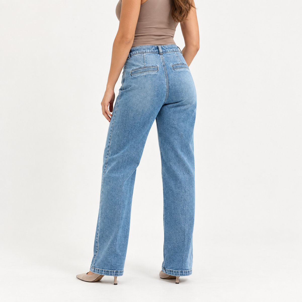 Close-up of the RISEN jeans’ high-rise waistband, button closure, light wash, and structured denim.