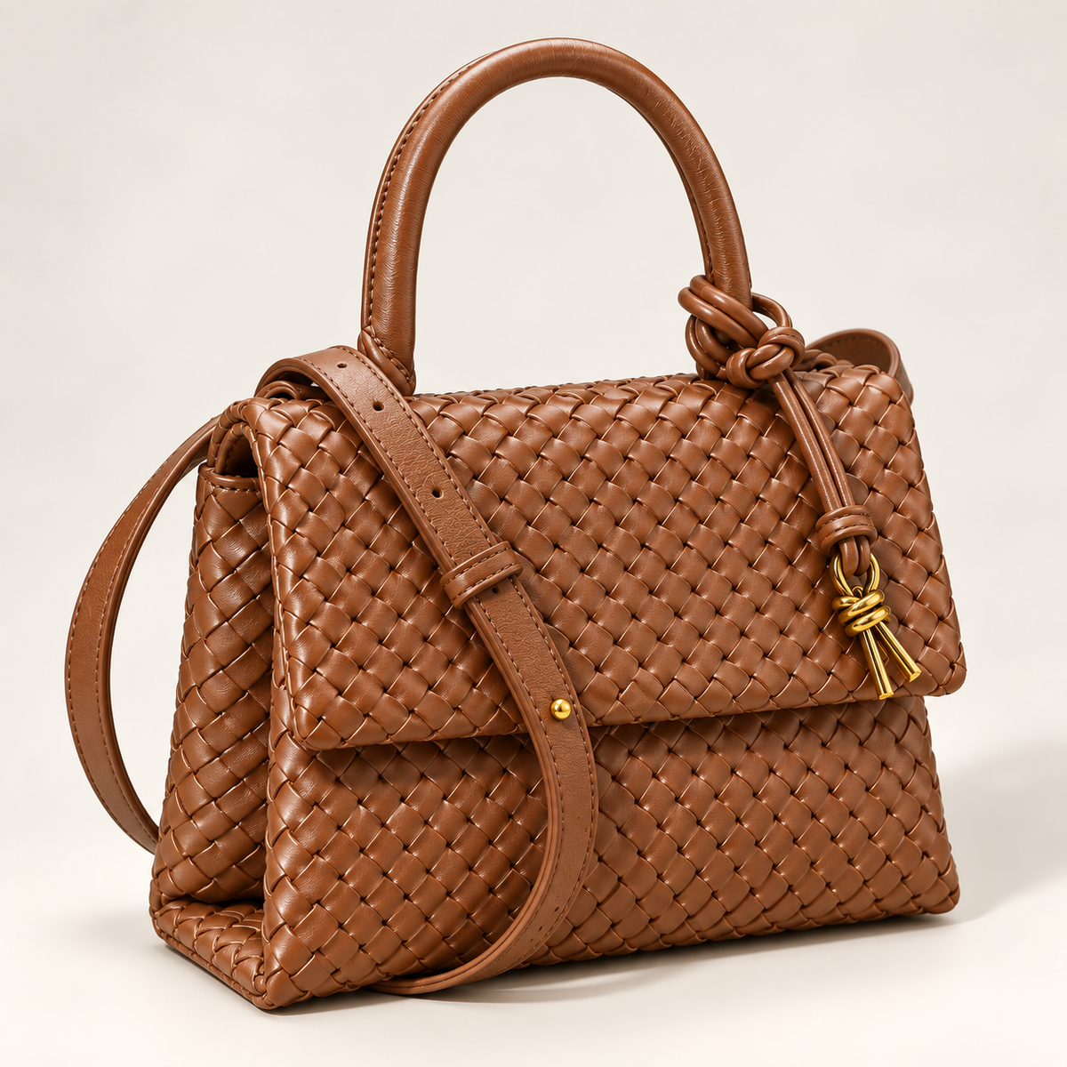 Brown Sutton woven faux leather handbag with top handle, crossbody strap and knotted gold-tone accent