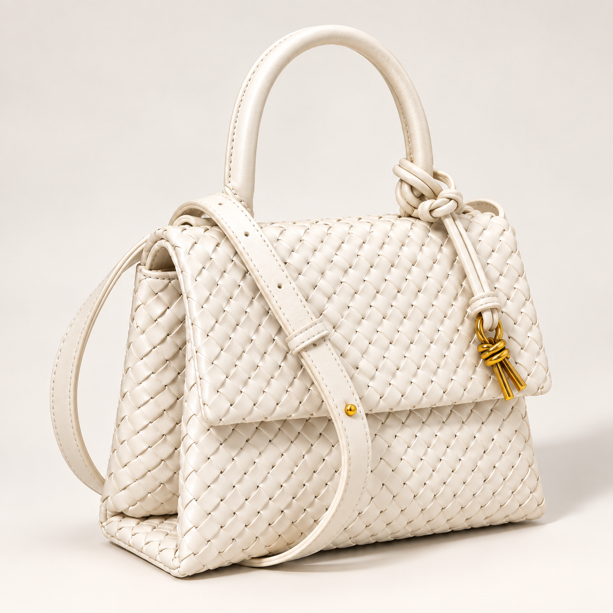 White Sutton structured woven handbag shown from an angled front view with detachable crossbody strap