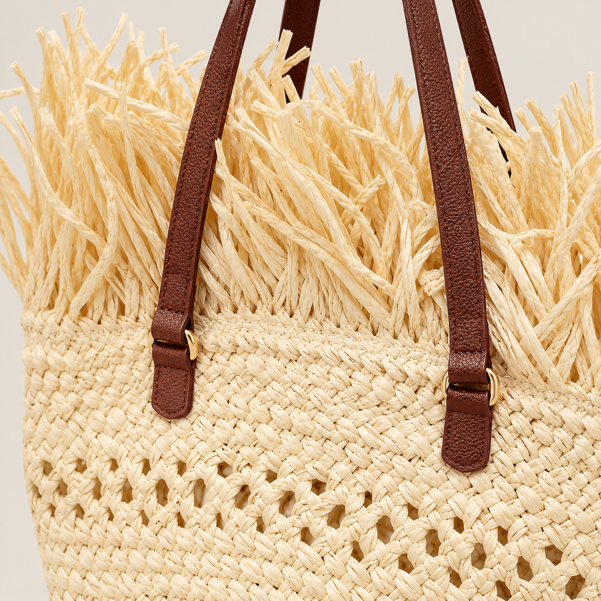 Close-up of Seaside Fringe tote showing ivory woven texture, fringe trim and brown handle details