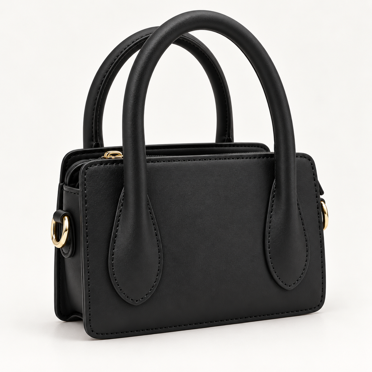 Angled view of black Park Avenue structured top handle handbag showing side hardware and clean rectangular shape