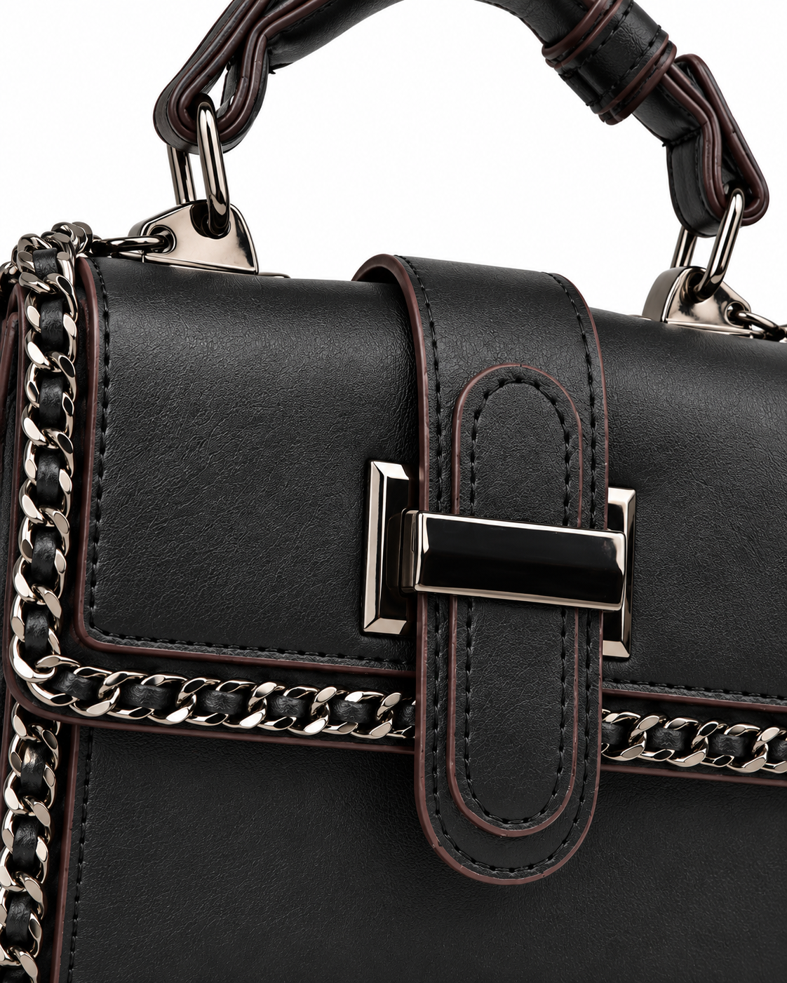 Angled view of black City Edge chain-trim crossbody bag with detachable shoulder strap