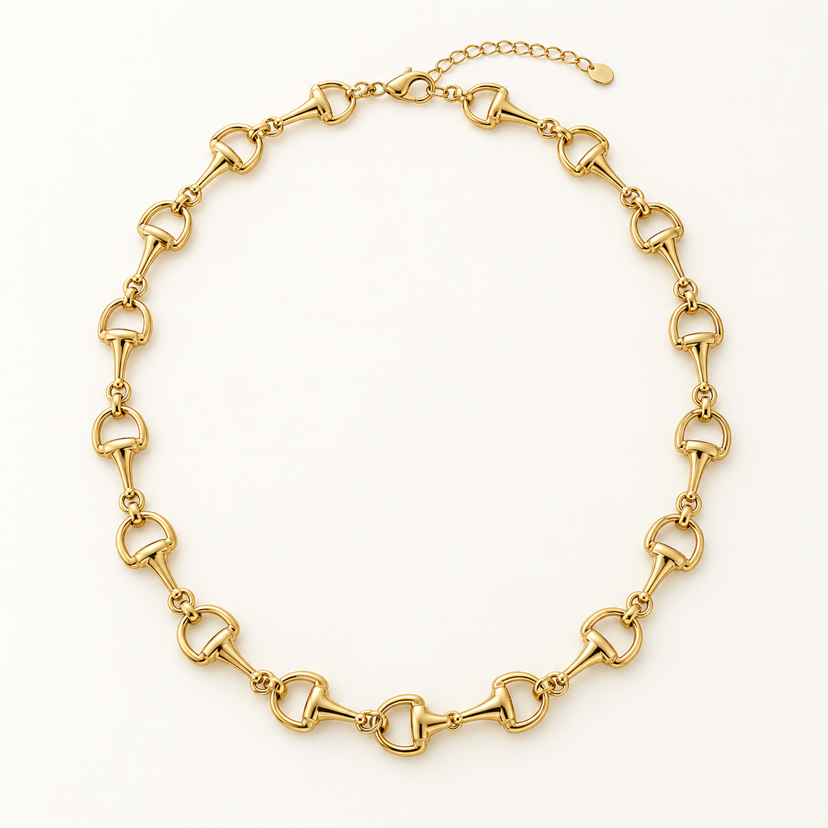 Classic gold horse bit chain necklace on ivory background