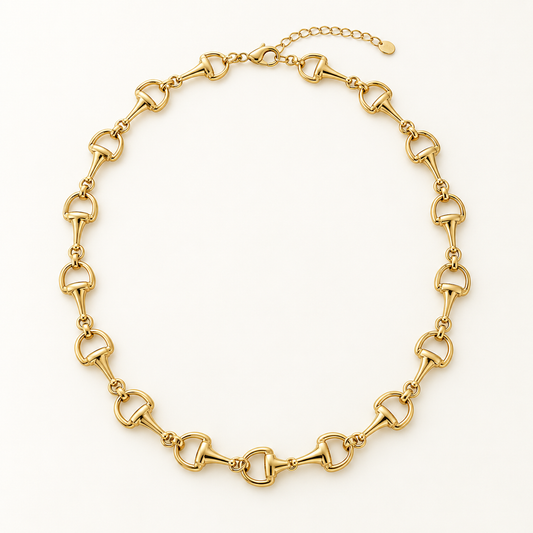 Classic gold horse bit chain necklace on ivory background