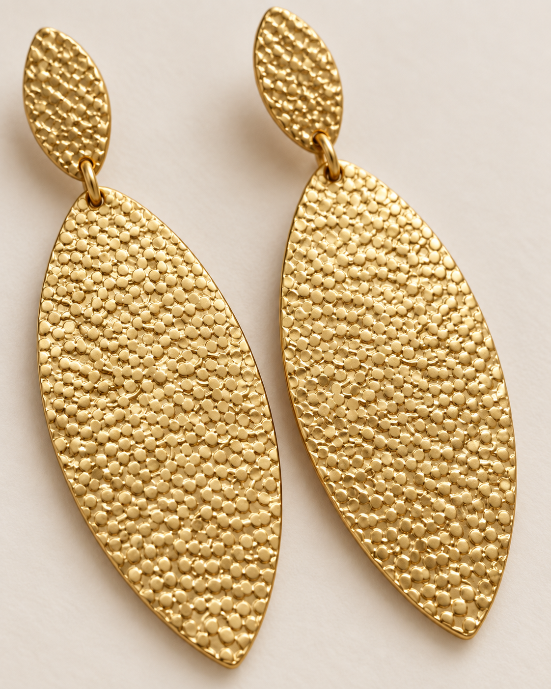 Close-up of hammered-style texture on Golden Hour elongated drop earrings