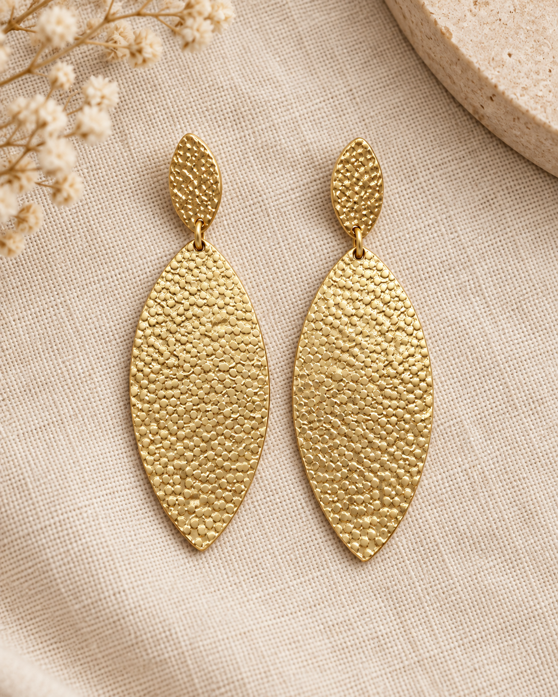 Golden Hour hammered-style earrings styled on neutral linen with soft natural accents