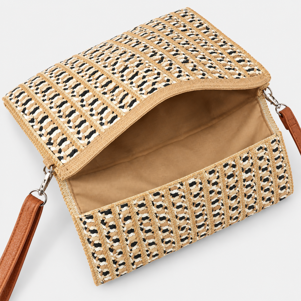 Open Coastal Mesa woven clutch showing tan interior lining and woven paper construction