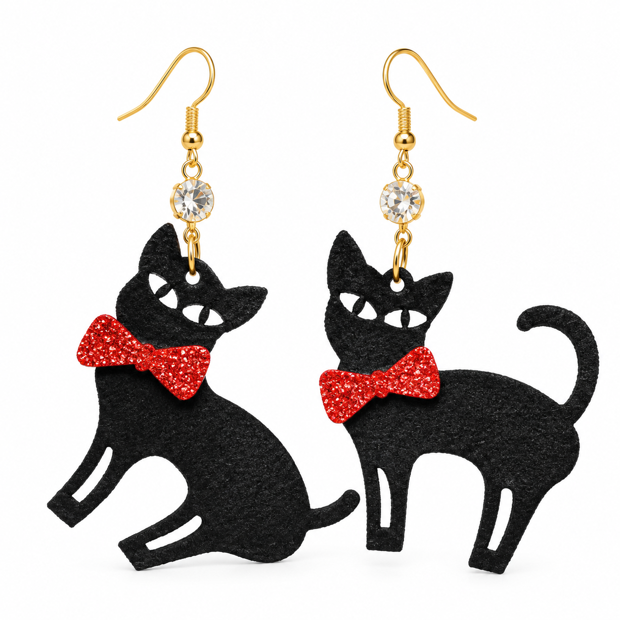 A pair of black cat-shaped dangle earrings with red glitter bow ties, gold-tone hooks, and clear rhinestone accents, shown on a plain white background.