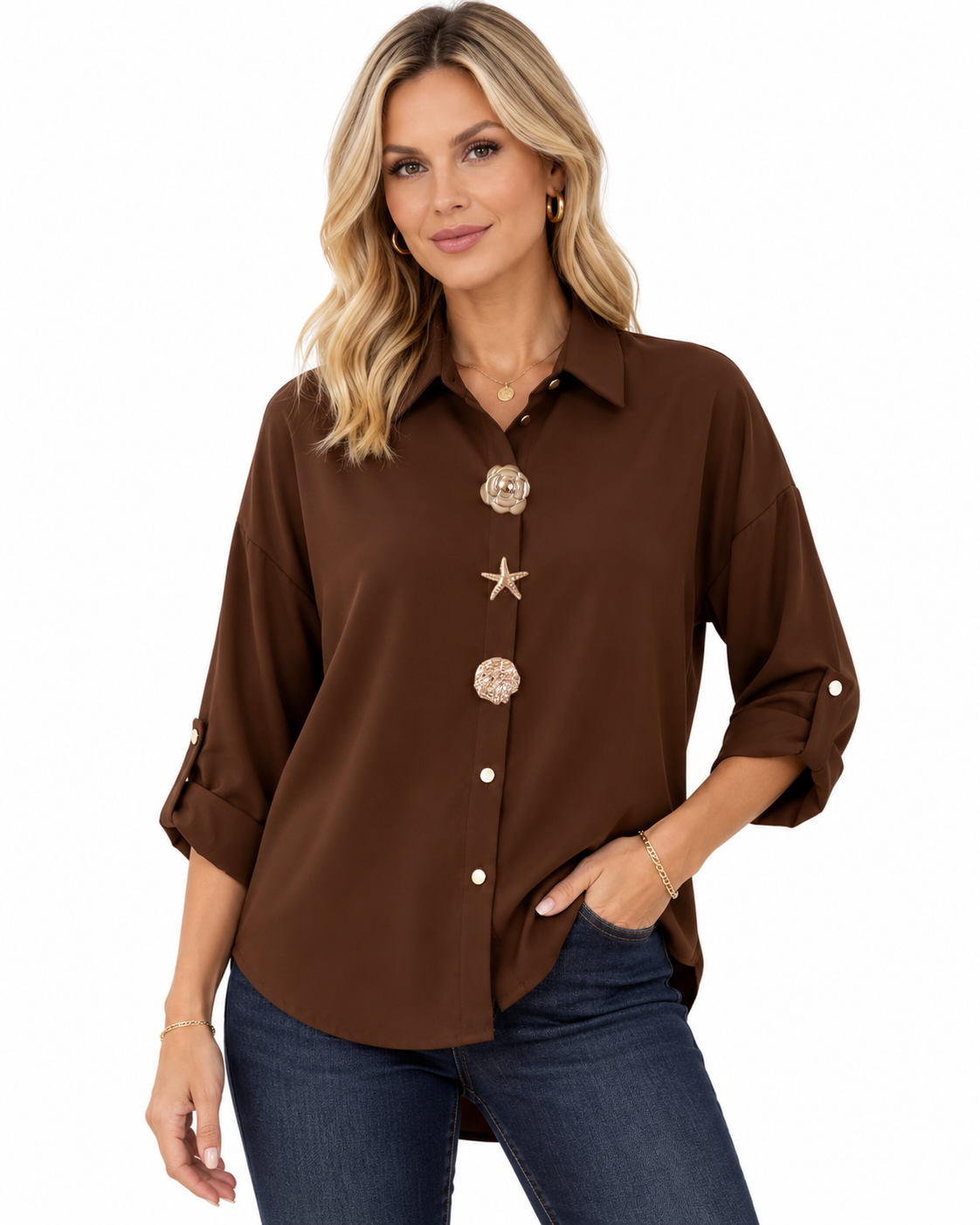 A woman modeling a brown button-up shirt with decorative starfish and shell buttons, paired with dark blue jeans, against a plain white background.