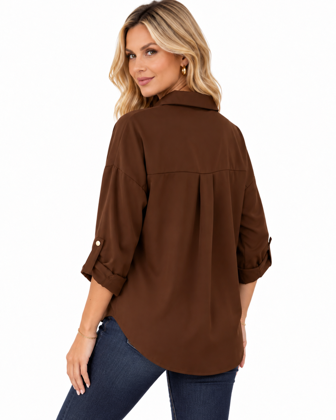 A woman wearing a brown long-sleeve button-up shirt with rolled cuffs and blue jeans, shown from a three-quarter back angle against a plain white background.