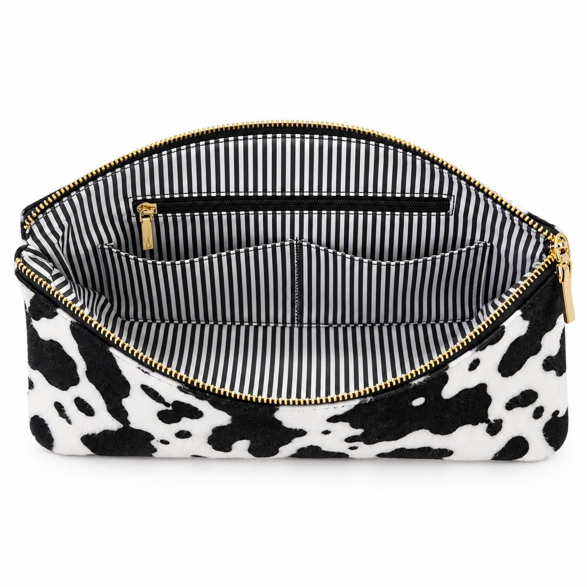 Cow print foldover clutch open to show striped lining, slip pockets, and interior zipper pocket