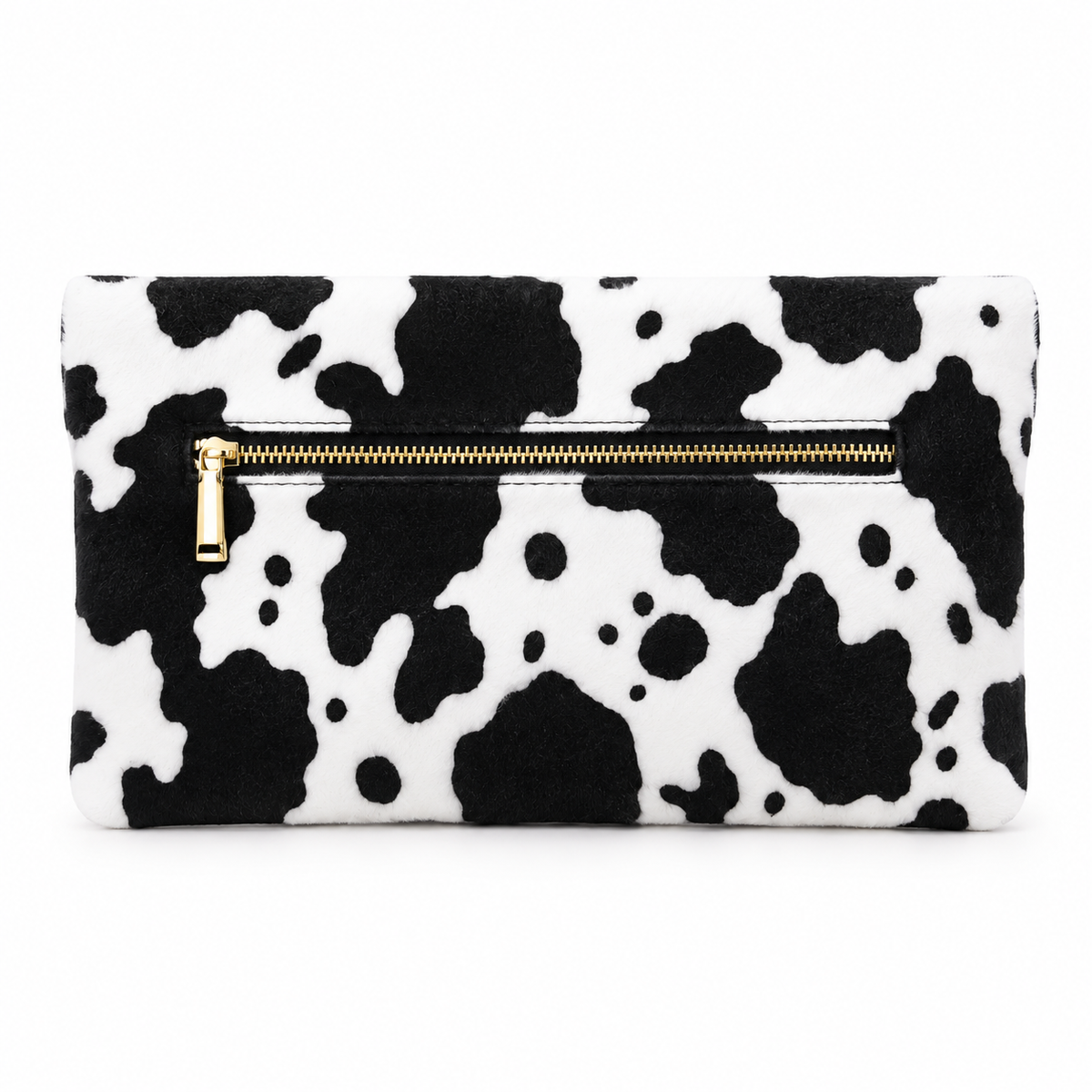 Black and white cow print clutch shown at an angle with gold zipper hardware