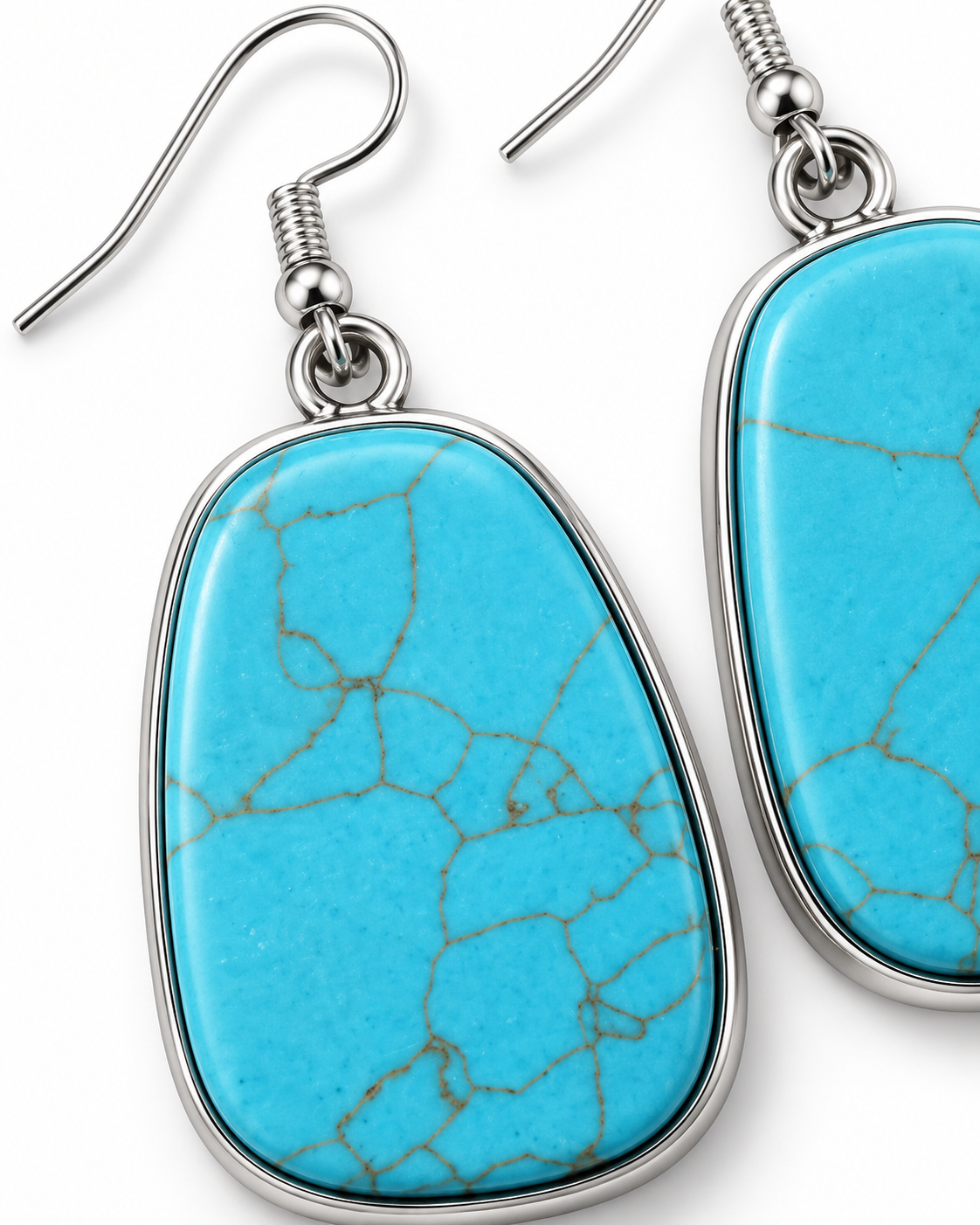A pair of silver-tone drop earrings featuring organic-shaped turquoise blue stone pendants with natural crackle veining, shown against a plain white background.