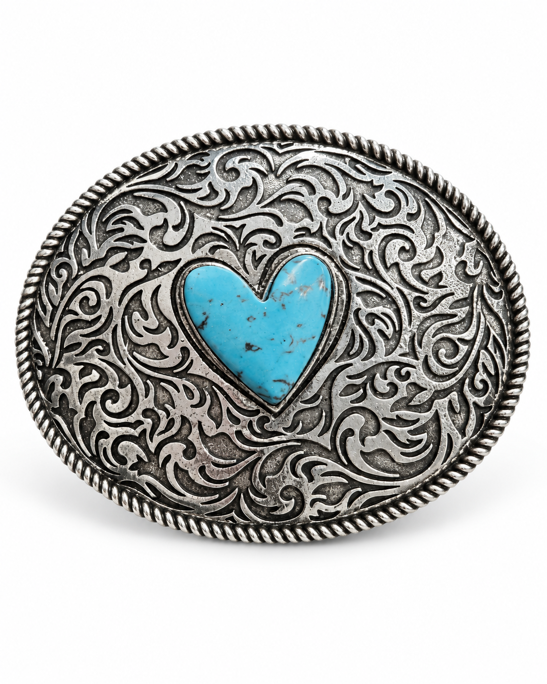 An oval silver-toned western-style belt buckle with intricate scrollwork engraving and a central turquoise heart inlay, shown on a plain white background.