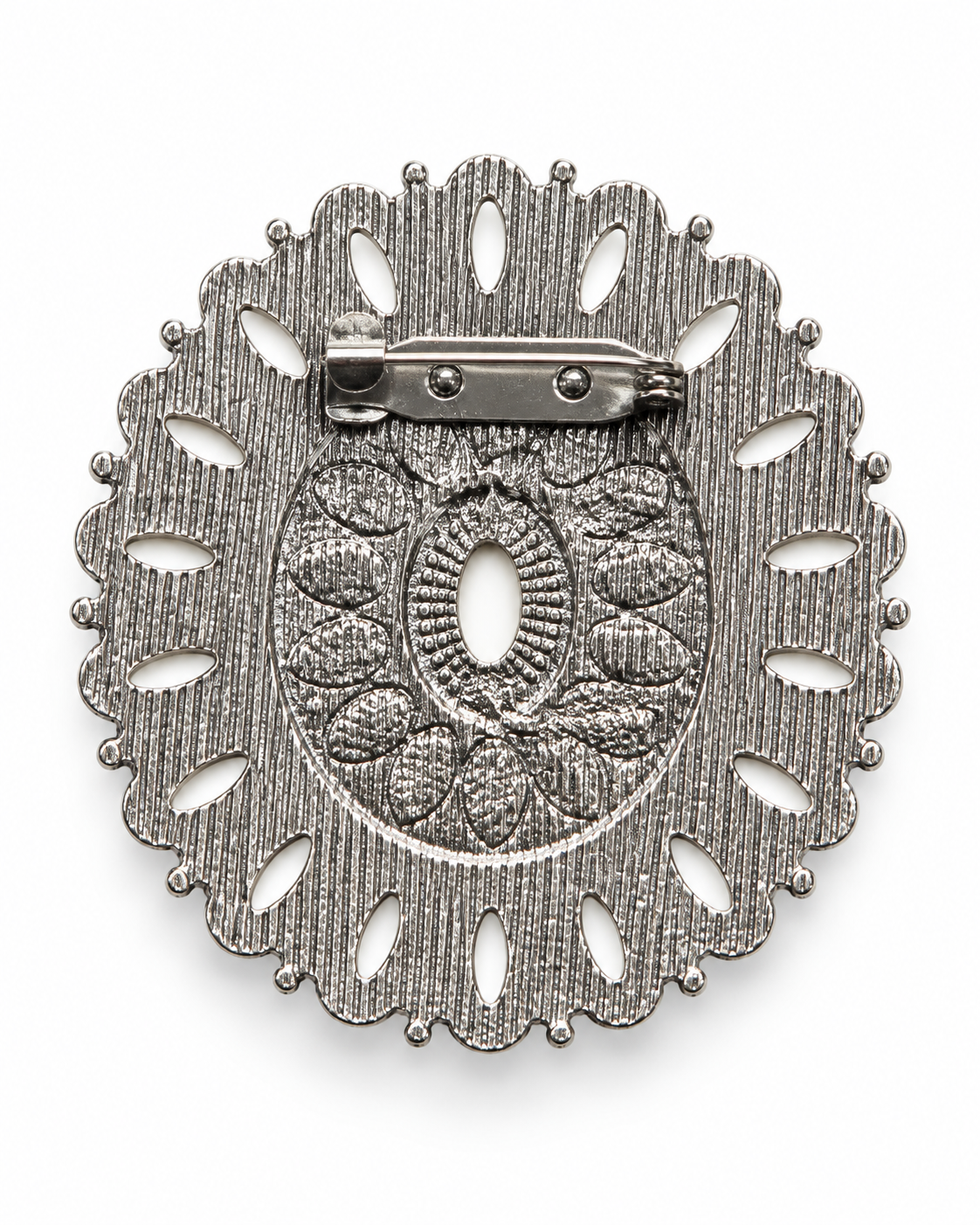 A silver-toned oval brooch with a textured, floral filigree design and a pin clasp on the back, shown on a plain white background.