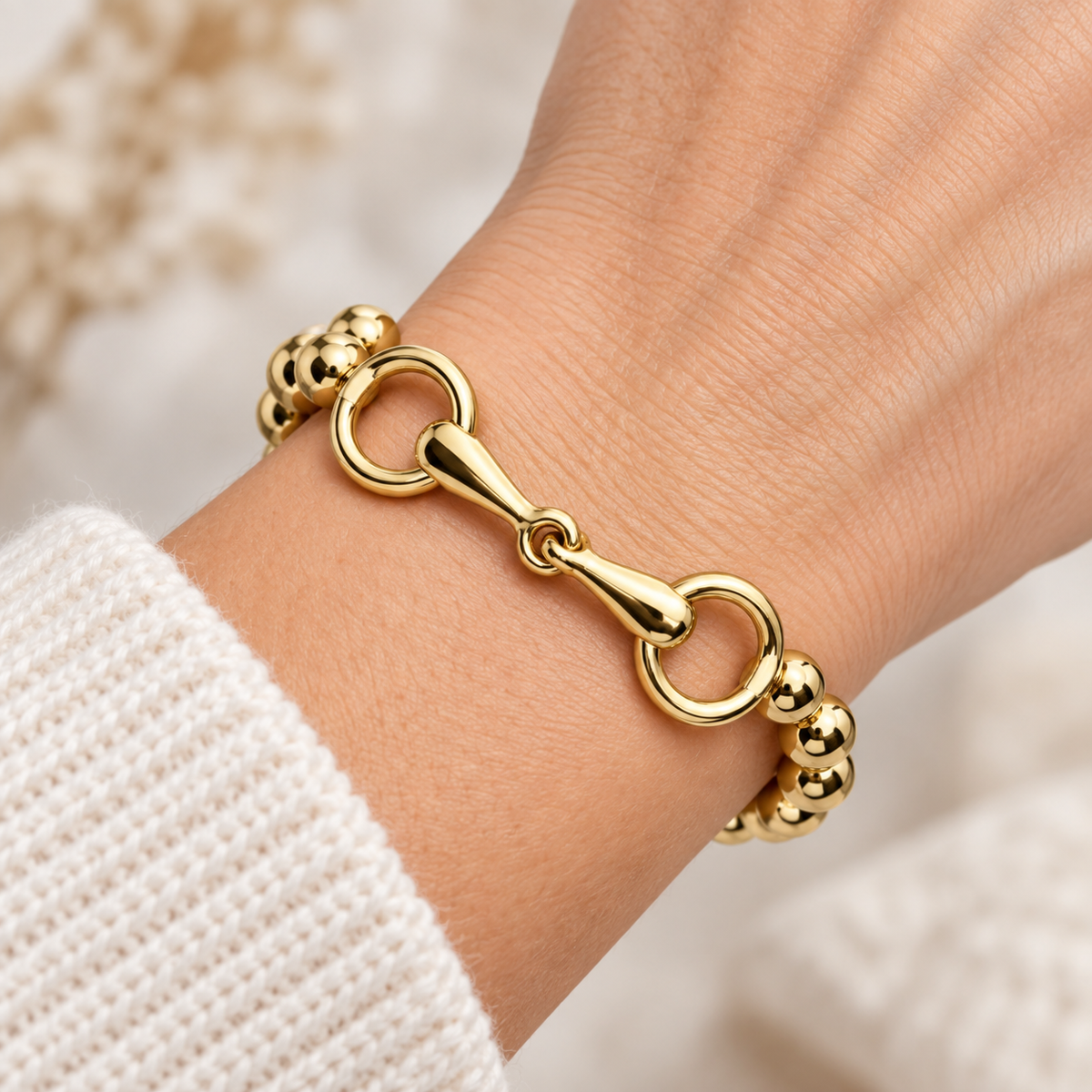 Gold-tone and silver-tone equestrian bracelets styled with denim and tooled leather