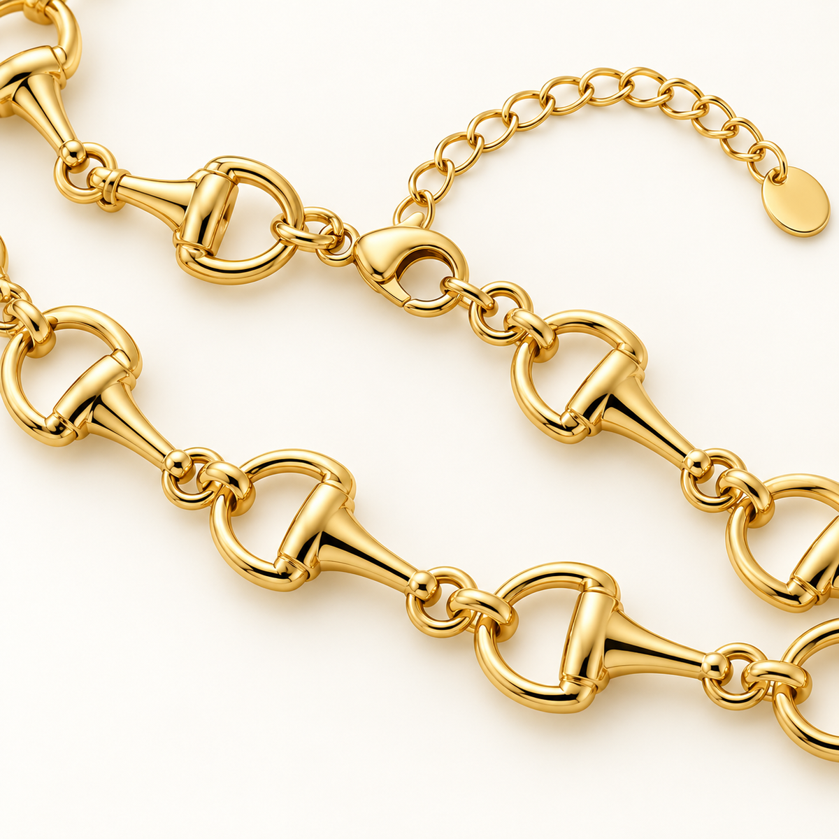 Close-up of classic gold horse bit chain necklace showing clasp, extender, and polished link detail