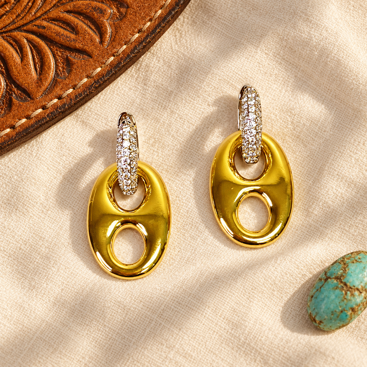 Gold horse bit earrings styled with leather and turquoise