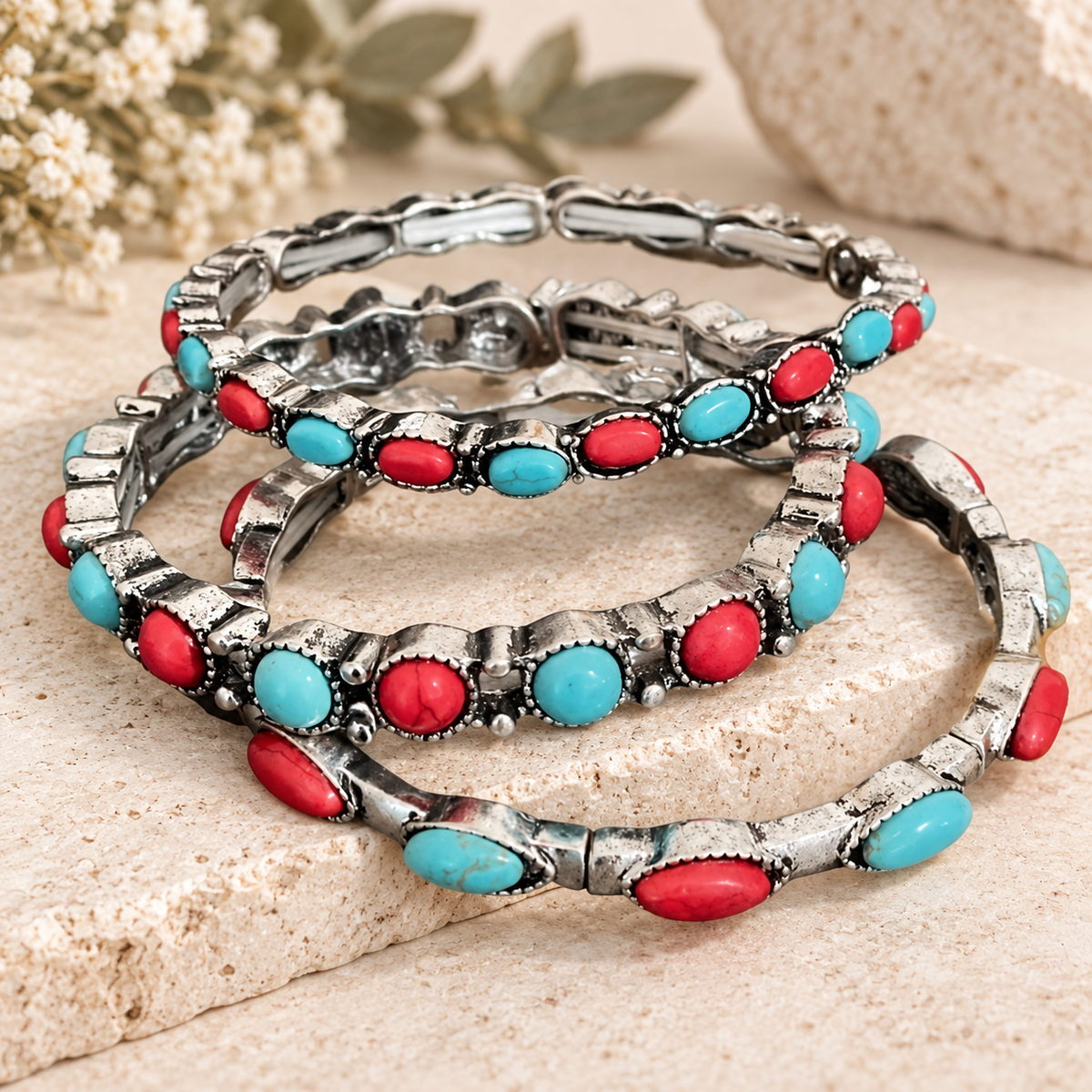 Desert Rodeo three-piece bracelet set styled on a neutral stone surface