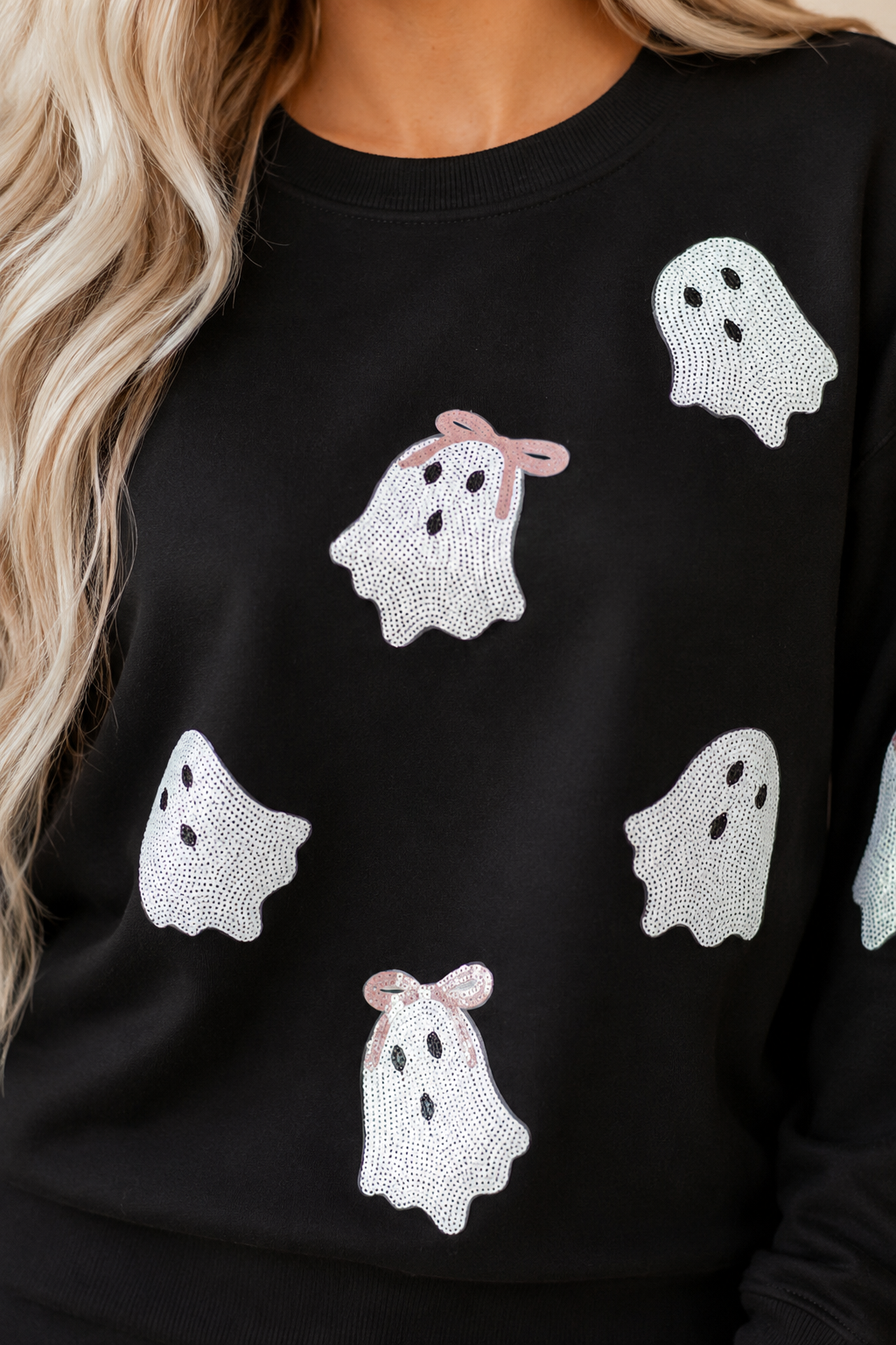 Close-up of the black Boo Bow Sequin Ghost Sweatshirt showing the sequin ghost details and bow accents.