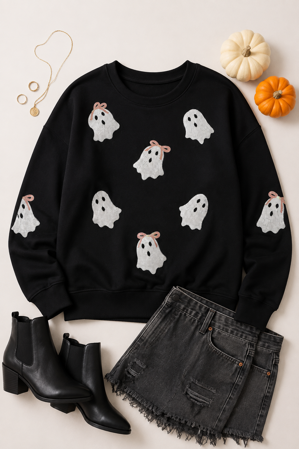 Flat lay of the black Boo Bow Sequin Ghost Sweatshirt styled with black denim, boots, and fall accessories.