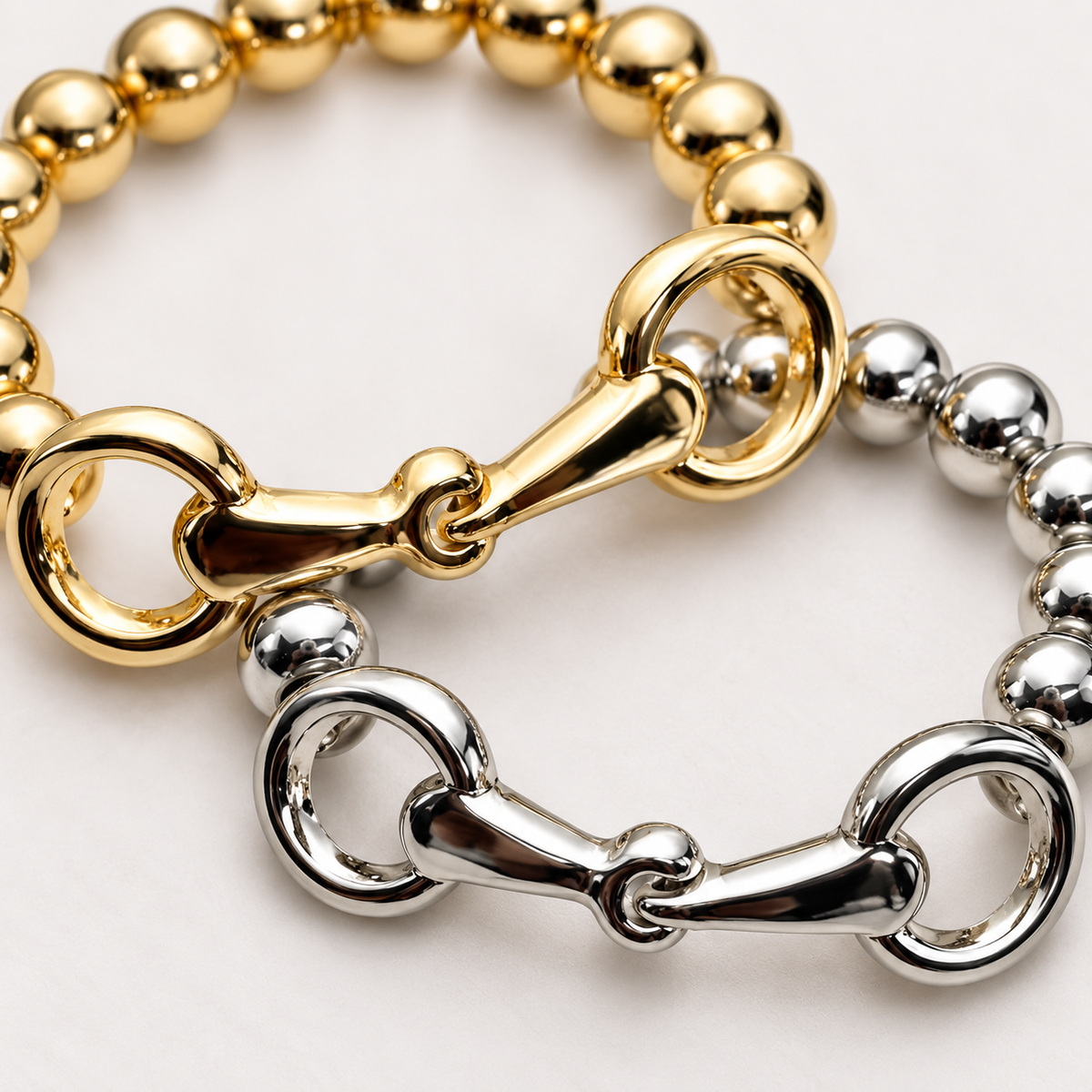 Close-up of gold-tone and silver-tone snaffle bit charms and polished metal beads