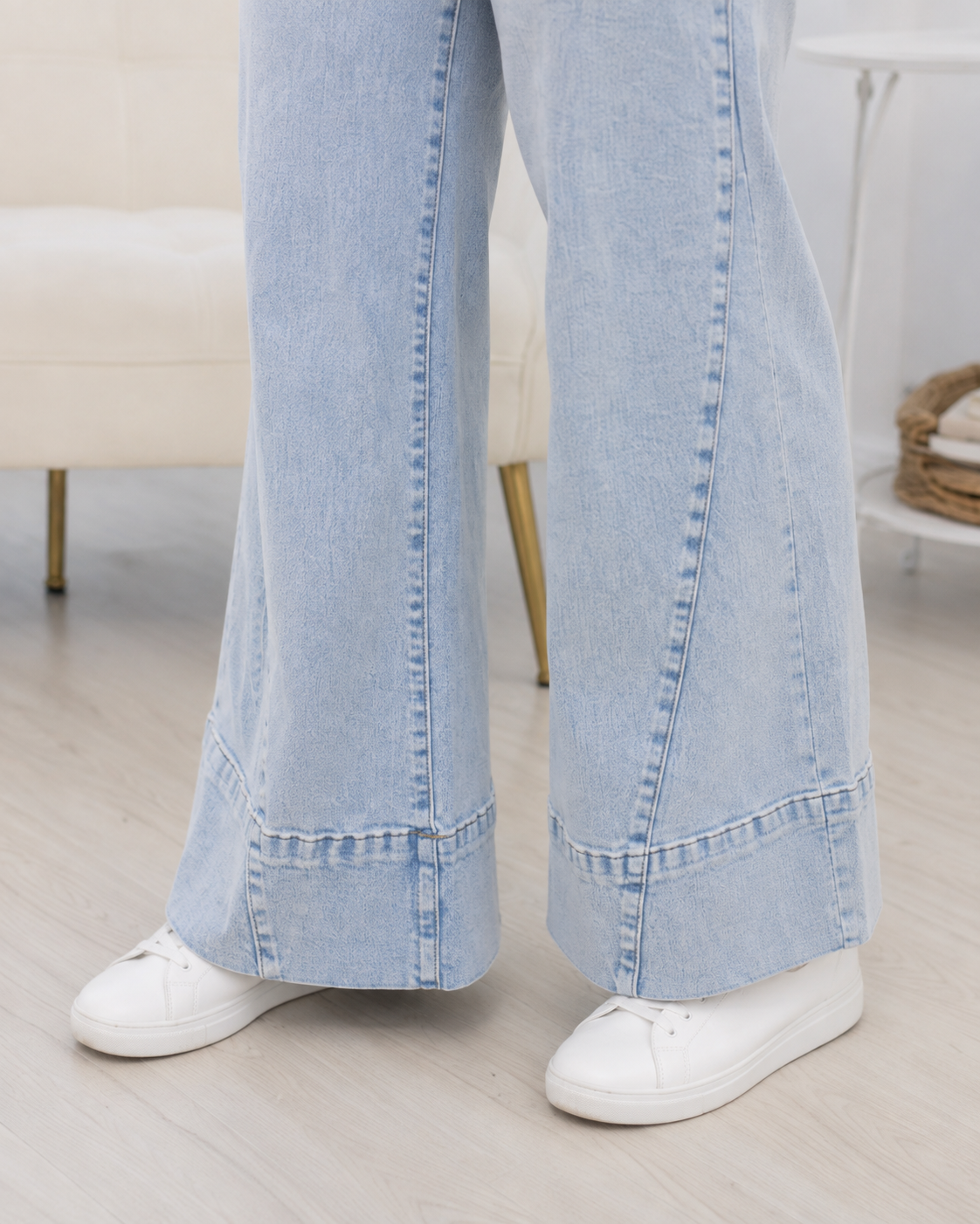 Close-up of Beau Blue wide-leg jeans showing the light-wash denim, vertical panel seams and oversized finished hem.