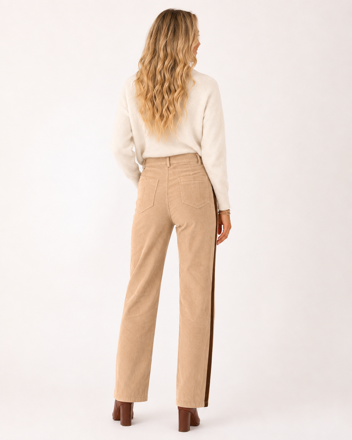 Back view of Emma wearing the Canyon Stripe Corduroy Pants, showing the back pockets, straight-leg fit and contrast side stripe.
