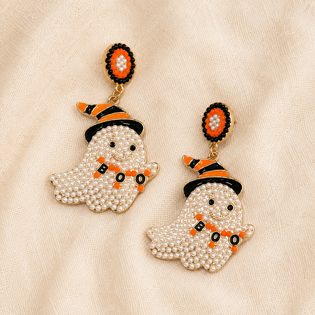 Close-up of pearl ghost BOO dangle earring with orange and black witch hat