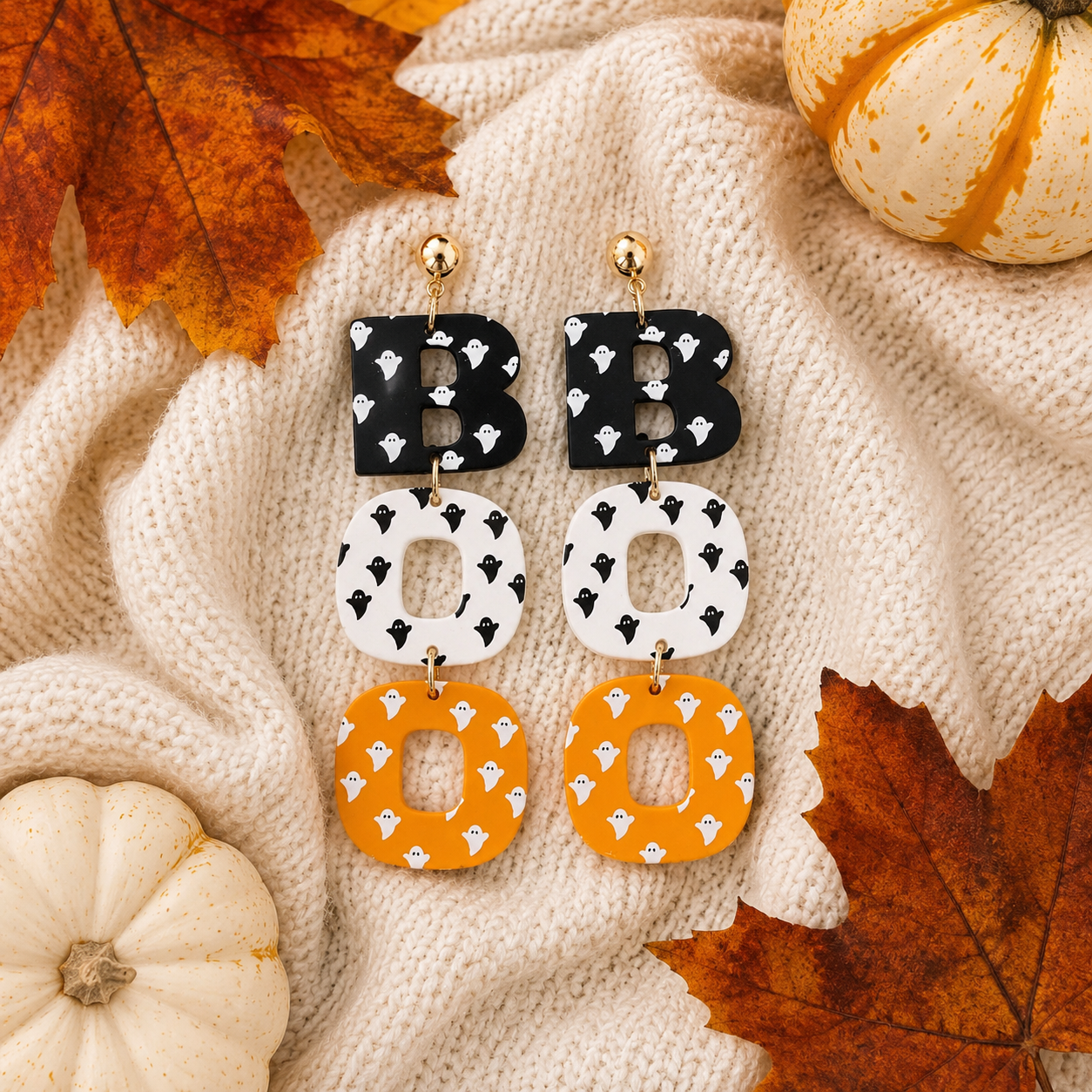 Ghostly BOO Statement Earrings styled on cream knit with pumpkins and autumn leaves
