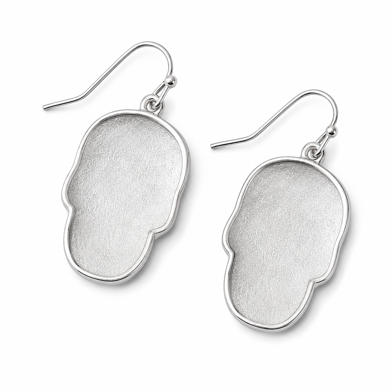 Back view of silver-tone skull earrings showing smooth metal backs and fishhook ear wires