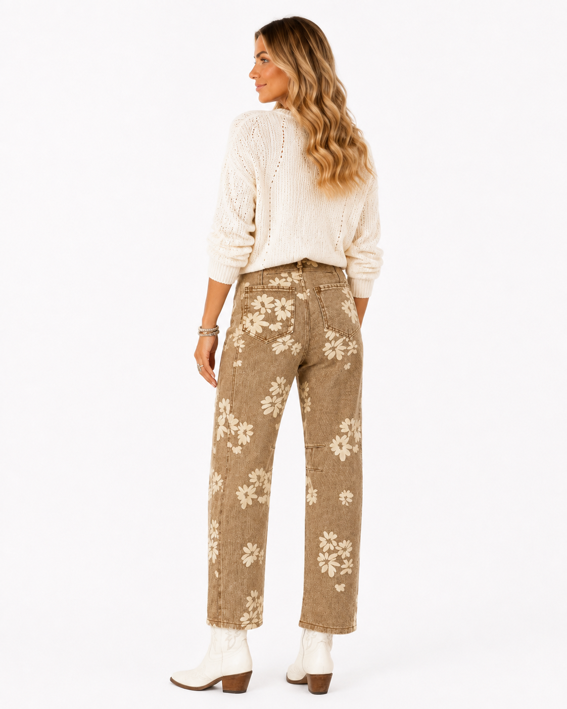 Front view of Emma wearing the khaki Prairie Bloom floral jeans with a cream sweater, showing the high rise, cream daisy print and relaxed straight-leg fit.