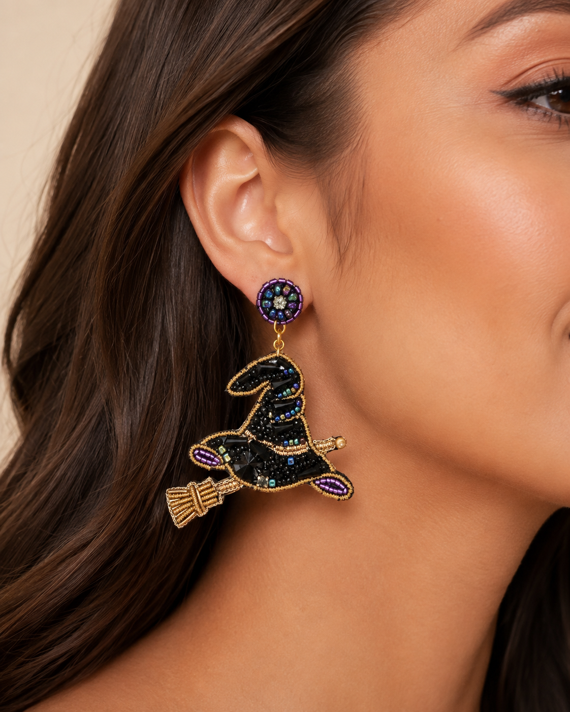 Close-up of woman wearing Midnight Coven black and purple beaded witch hat statement earring