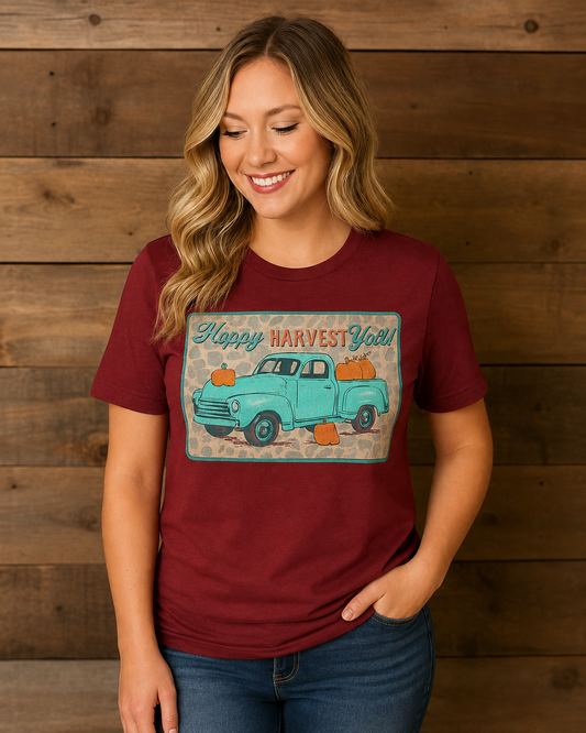 Harvest Roads burgundy graphic tee featuring a turquoise vintage pickup truck, pumpkins and Happy Harvest Y’all lettering on a model