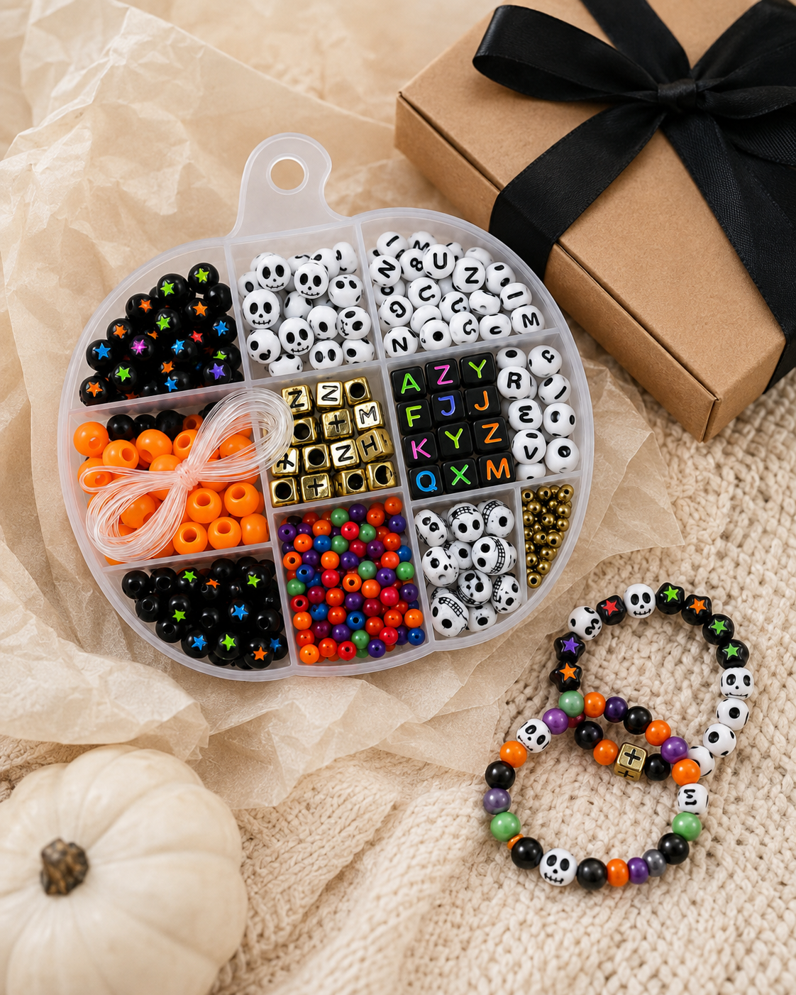 Halloween DIY bracelet kit styled on a craft table with finished spooky bracelets, letter beads and colorful bead accents