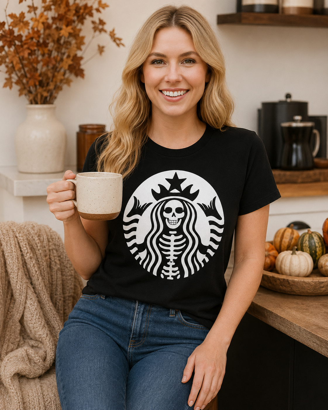 Emma wearing Afterlife Coffee Club tee while holding a coffee mug in a cozy autumn kitchen setting