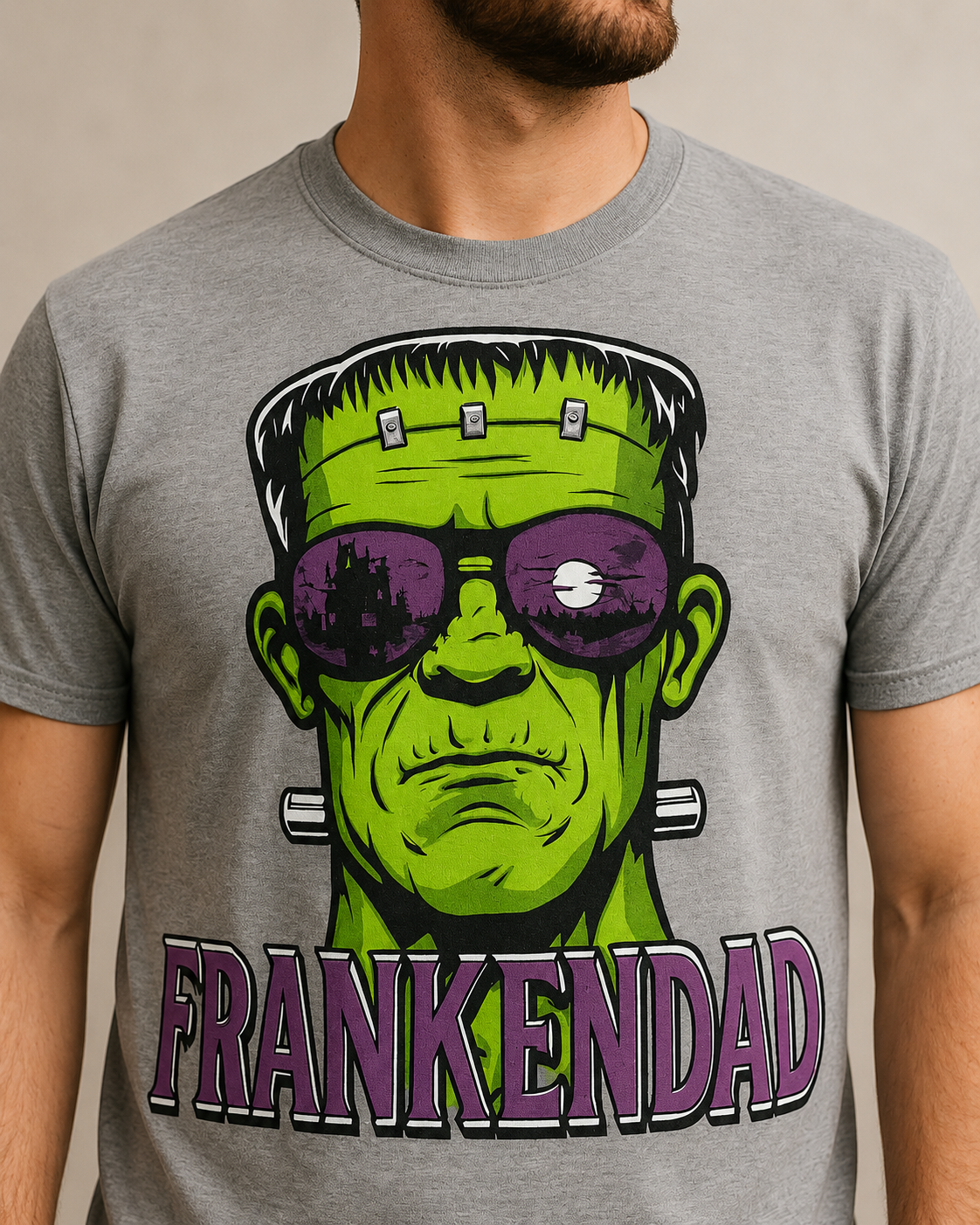 Close-up of FrankenDad graphic showing neon green monster face, purple sunglasses and bold purple FRANKENDAD lettering